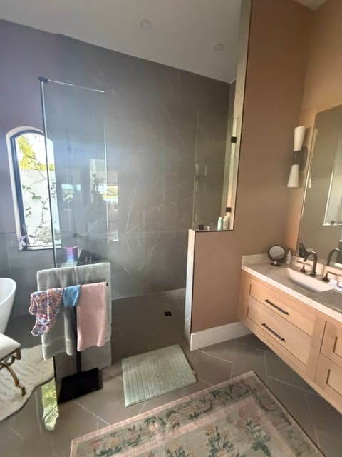 Modern walk-in shower with floor-to-ceiling stone tile