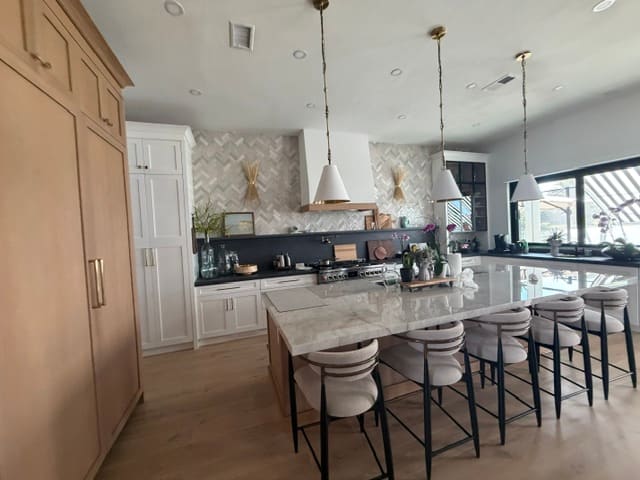 Luxury Naples kitchen remodel with marble island and designer pendant lighting