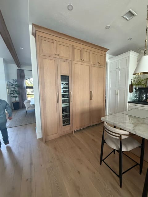 Custom oak built-in pantry with integrated wine storage