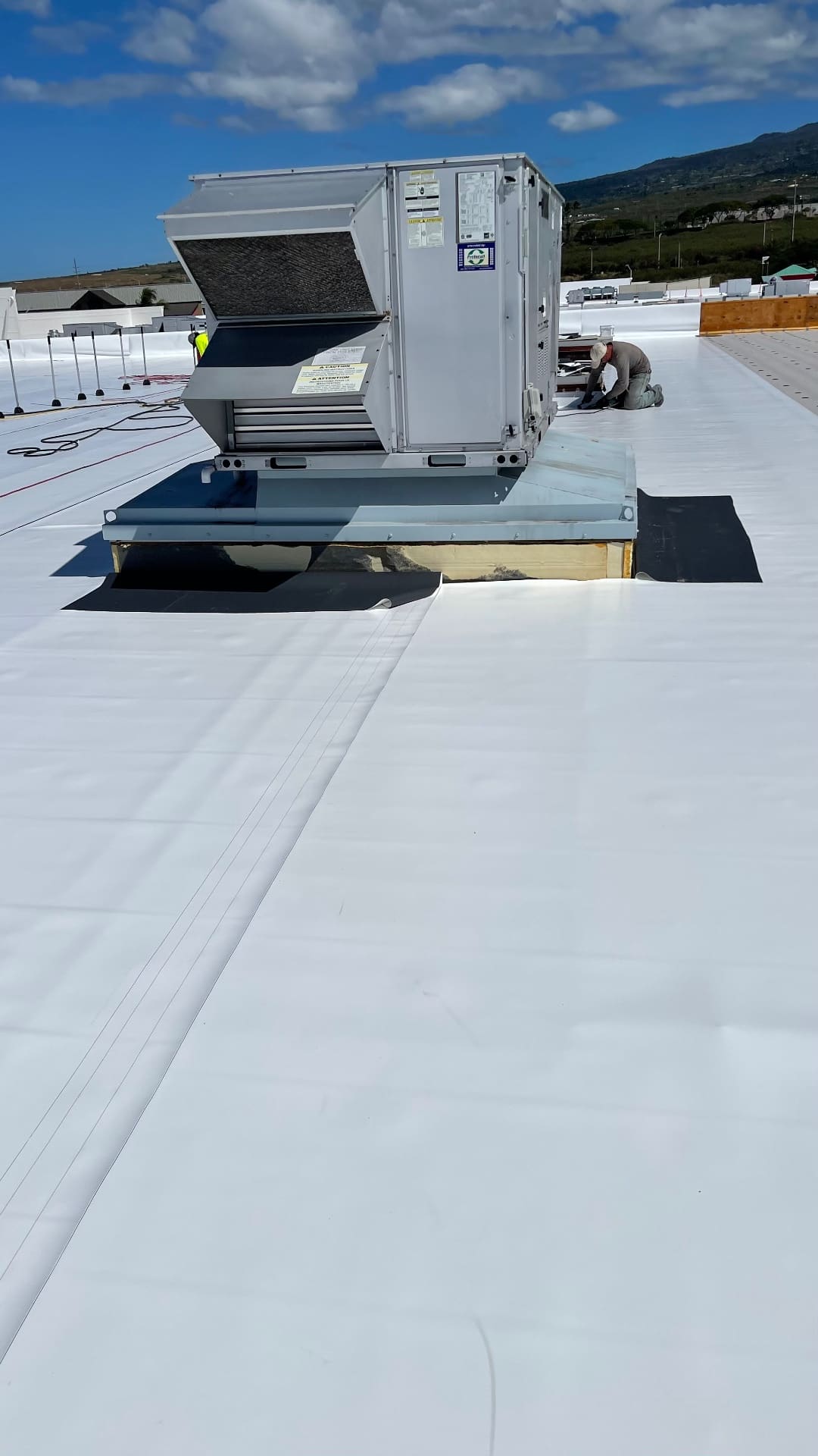 Detailed TPO flashing around rooftop HVAC curb on commercial building