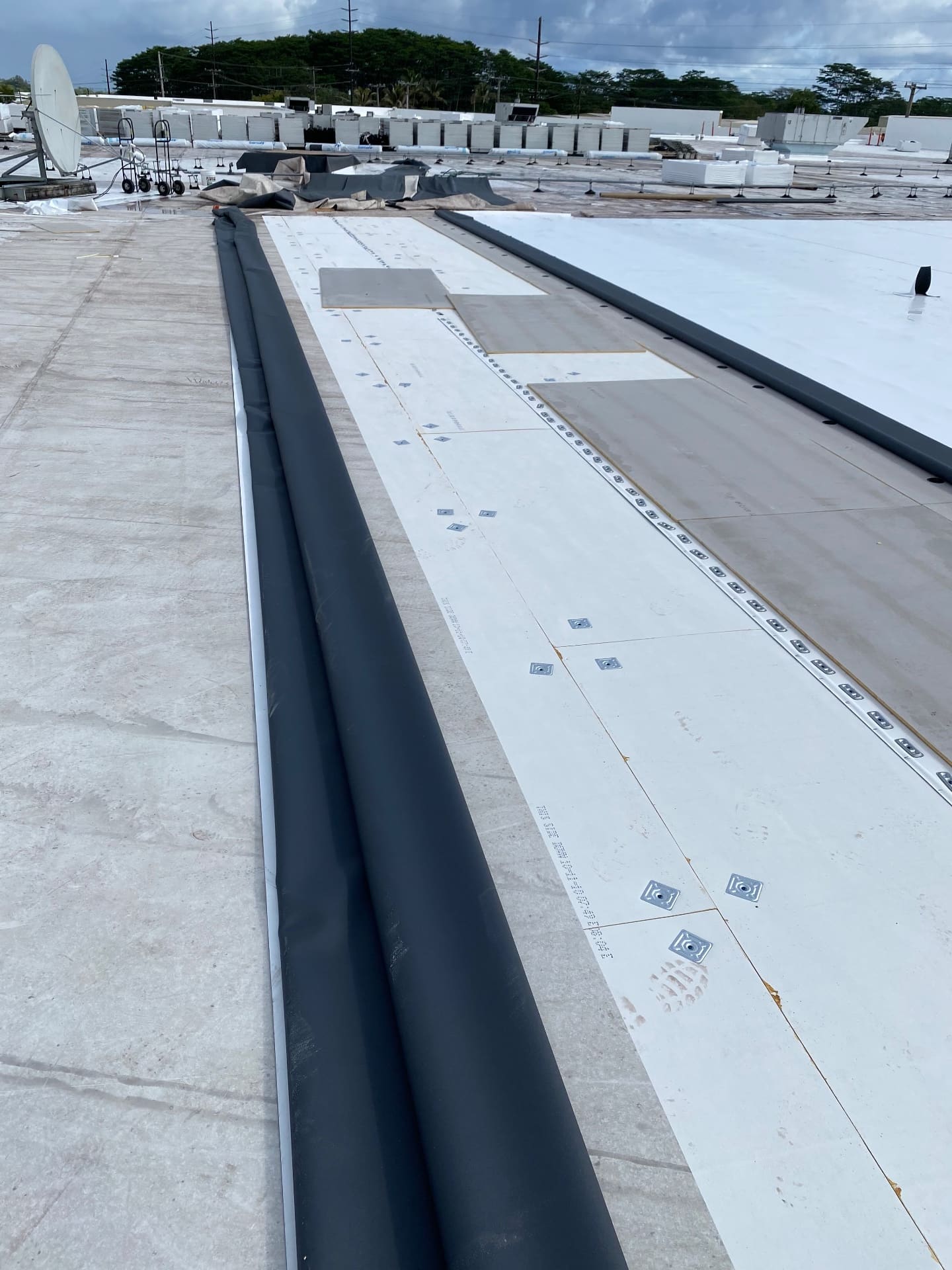 Close-up detail of commercial TPO roofing installation and membrane layout