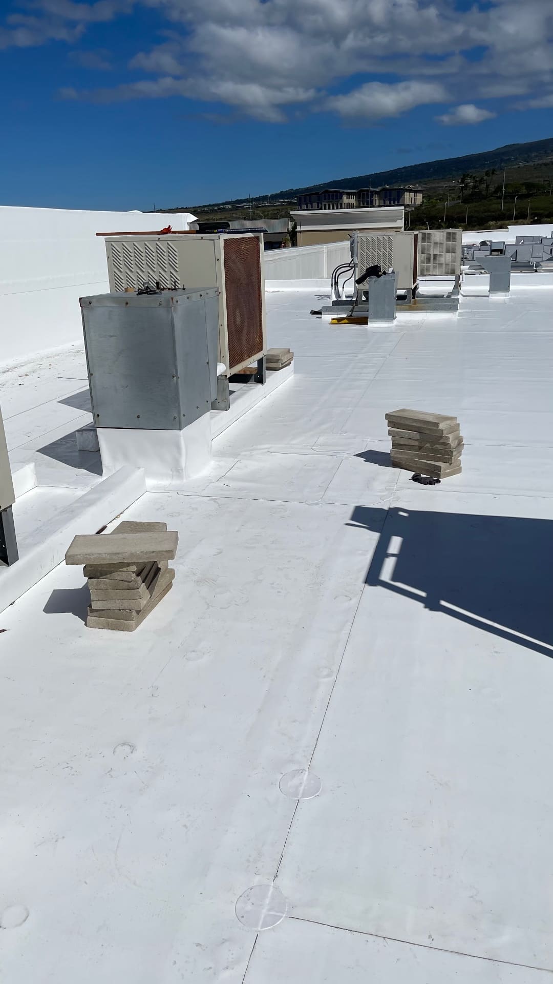 Commercial TPO roof installation around multiple rooftop mechanical units