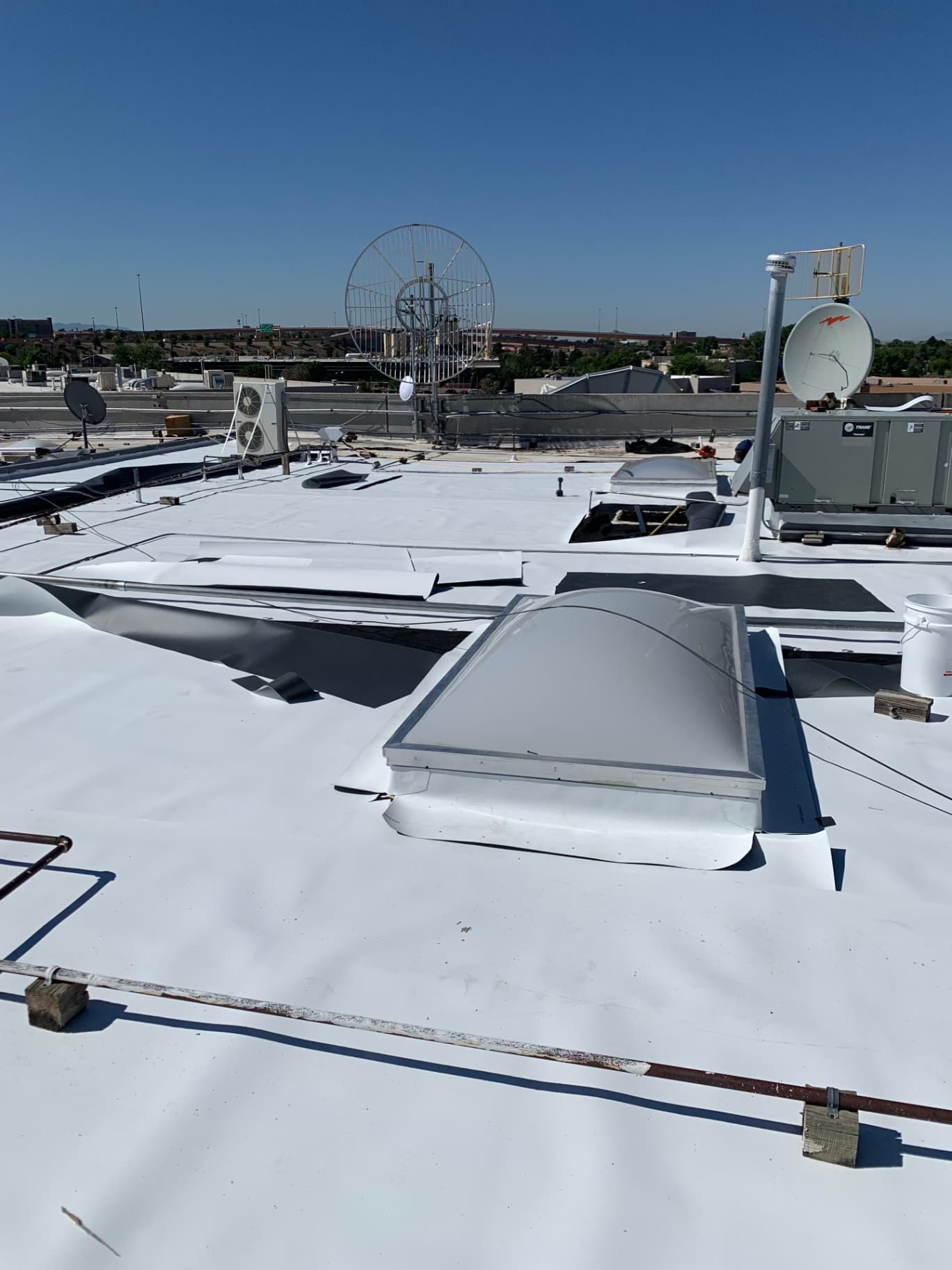 TPO membrane and flashing installed around dome skylights on commercial flat roof